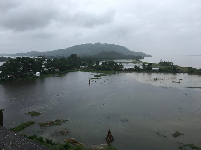 Picture : The Brahmaputra (in the background) overflows its banks near Dhubri in Lower Assam during the August 2017 flood [Image by Sucharita Sen