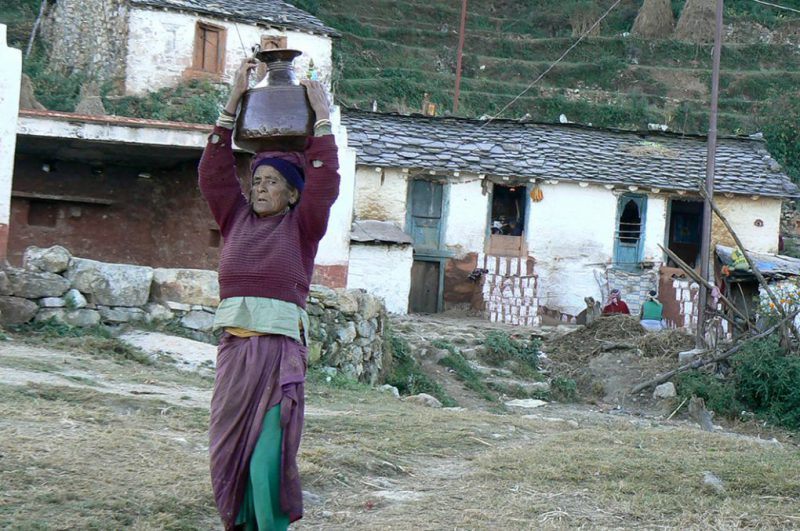 In the Himalayas, most women have to walk miles on hilly terrain to fetch water as local water sources are depleting [Image by Hridayesh Joshi]