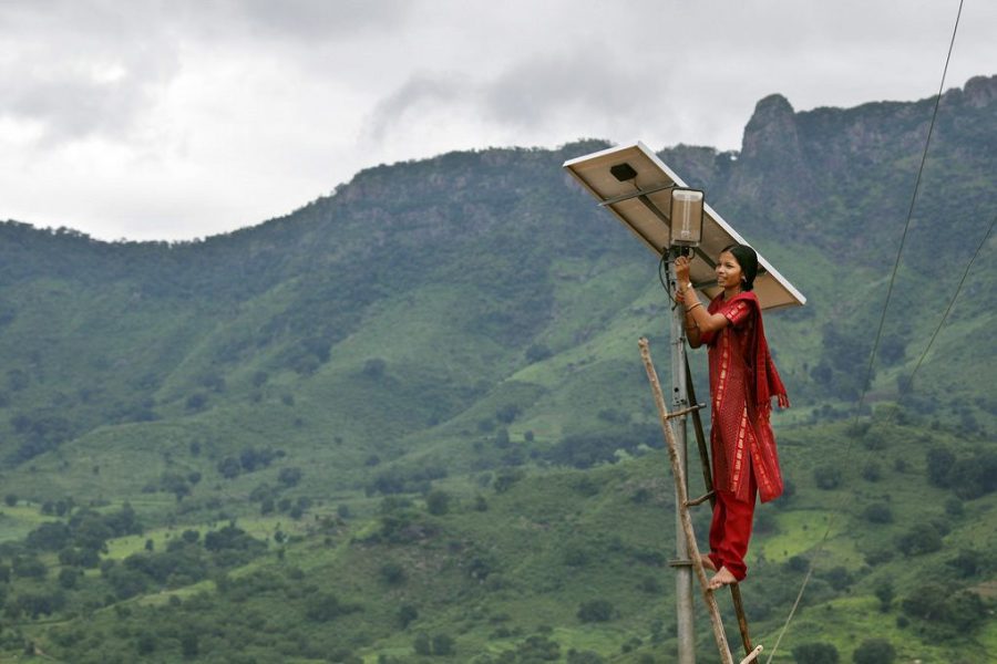 Meenakshi Dewan doing maintenance work on a solar street lighting in her village of Tinginaput, India [image by Abbie Trayler-Smith / Panos Pictures / Department for International Development]