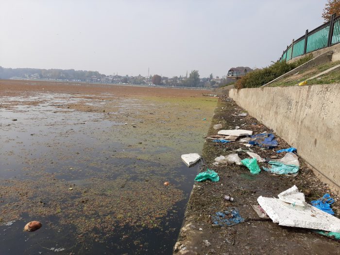 As municipal services ground to a halt trash piled up [image by: Faisal Bhat]