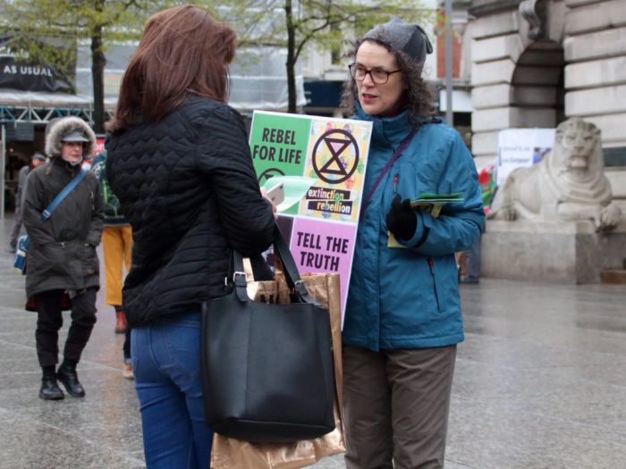A campaigner informs a pedestrian about extinction level threats [image by: kthtrnr/Flickr]
