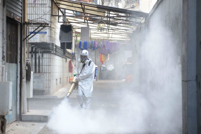 A volunteer sprays disinfectant in Changsha, Hunan province [image: Alamy]
